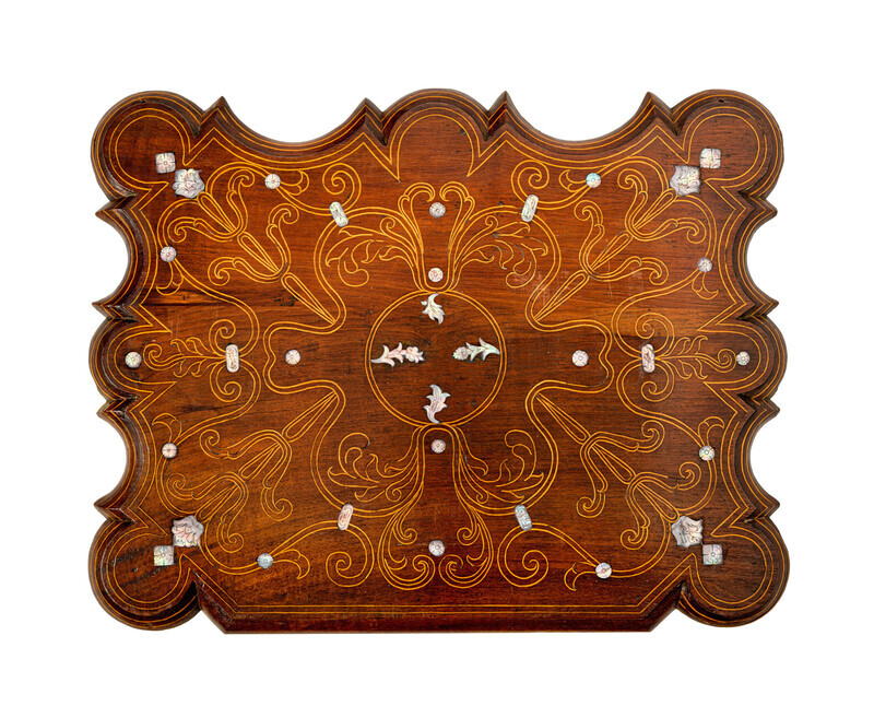 Detail of fall front desk of cabinet, made of a light-colored wood with mother-of-pearl inlay. Photographed on a white background.