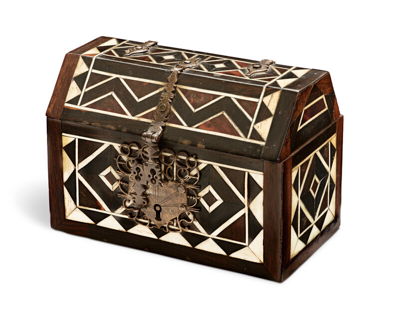 Wood and tortoiseshell casket with iron fittings and geometric bone inlay, photographed on a white background.